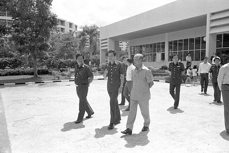 President Wee Kim Wee leaving Traffic Police headquarters in Maxwell Road for Road Safety Park at East Coast. With him are Senior Parliament Secretary for Home Affairs Chin Harn Tong (behind, left of President) and Police Commissioner Goh Yong Hong (behind, right of President).