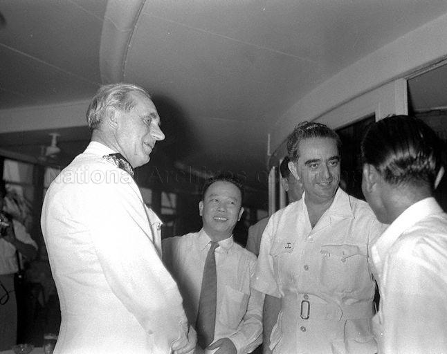 Retiring Governor of Singapore Sir John Nicoll with Chief Minister David Marshall (second from right) and other officials before he departs for London from Singapore.