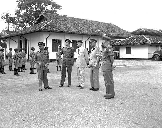 Governor of Singapore Sir Robert Black visiting Singapore Military Forces headquarters. Standing second from left is Officer Commanding 'C' Company Major John E Gabain.