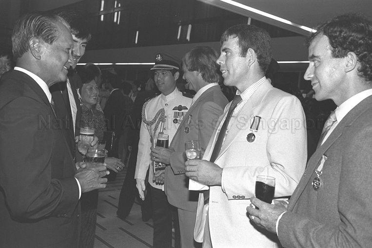 President Wee Kim Wee in conversation with recipients of the Conspicuous Gallantry Medal (Pingat Gagah Perkasa) award for their involvement in tunnelling rescue works during the Hotel New World collapse. The award recipients are from right, Senior Inspector-of-Works, Mass Rapid Transit Corporation (MRTC) Michael Joseph Prendergast, Senior Inspector-of-Works, MRTC Tom Gallagher and Senior Inspector-of-Works, MRTC Patrick Joseph and Gallagher (partially hidden, second from left).