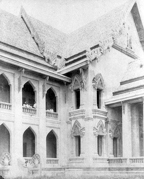 Maha Chulalongkorn Building belonging to Faculty of Arts of Chulalongkorn University in Bangkok, Thailand. At the bottom left corner is Italian sculptor Rodolfo Nolli, who made several ornamental details installed on the building including the nagas on the exterior staircases and the inlays on the gables.