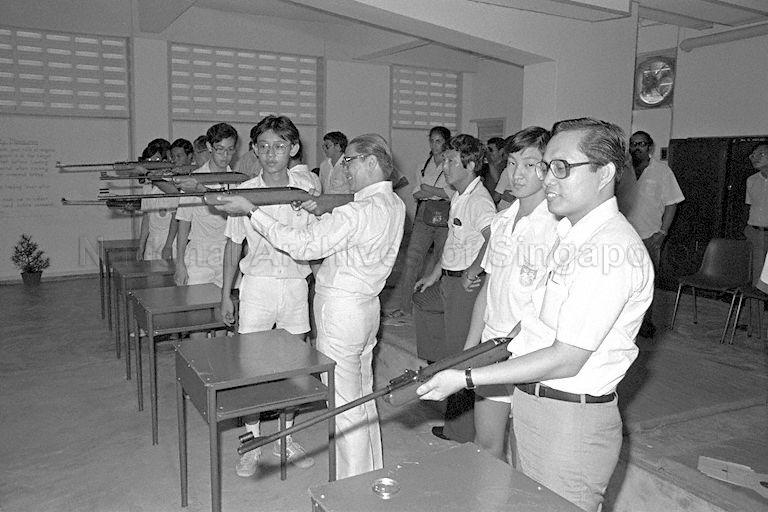 Ministerial shoot-out at Hua Yi School's air rifle club .... lining their sights on targets 10 metres away (from right) are Member of Parliament (MP) for Telok Blangah Rohan Kamis, Trade and Industry Minister Dr Tony Tan, Minister of State for Labour as well as Chairman of National Productivity Board Dr Wong Kwei Cheong (hidden), Senior Parliamentary Secretary to Prime Minister's Office and also MP for Tiong Bahru Ch'ng Jit Koon, and Parliamentary Secretary to Ministry of Trade and Industry and Social Affairs Sidek Saniff (hidden).