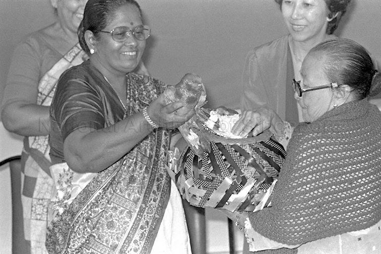 First Lady Mrs C V Devan Nair (left) releasing one of the