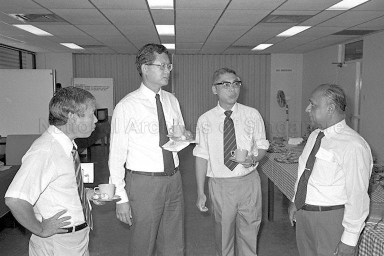 Minister of State for Education Dr Tay Eng Soon (second from left) at a reception following the opening of the three-day symposium on "Research on Biology and Biotechnology in Developing Countries" held at the Science Faculty, National University of Singapore (NUS), Kent Ridge campus. Second from right is Commissioner of Parks and Recreation Dr Chua Sian Eng.