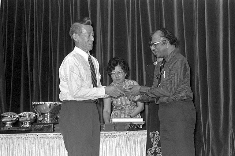 Dr S R Sayampanathan (right), a member of People's Association (PA) Board of Management, presenting the PA Long Service Awards to community leaders who had served for ten years or longer at World Trade Centre auditorium. The ceremony was officiated by Senior Minister of State, Prime Minister's Office and Deputy Chairman of PA Lee Khoon Choy.