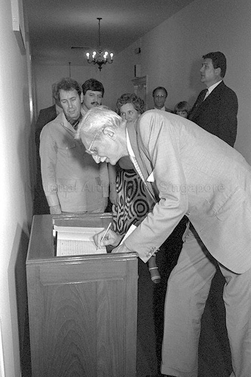Dr Herbert Hupka, leader of the visiting six-man West German Parliamentary team, signing the guest book during a call on Minister of State for Finance Lee Yock Suan and Deputy Speaker Hwang Soo Jin at Parliament House. Dr Hupka is a member of the Foreign Relations Committee of the German Federal Parliament.