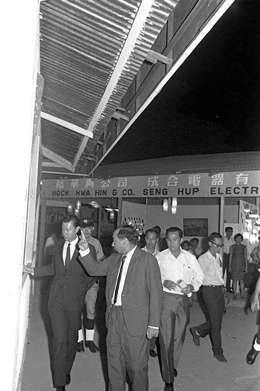 Minister for Finance Dr Goh Keng Swee leaving Gay World Amusement Park after the closing ceremony of Sinapore Festival 1968. On the far left is Dr. Goh Poh Seng. He was a novelist, poet, and playwright. At the time he was part of the National Theatre Trust and was instrumental in putting together the Singapore Festival of 1968. Goh also wrote what came to be known as the first Singaporean novel, If We Dream Too Long.