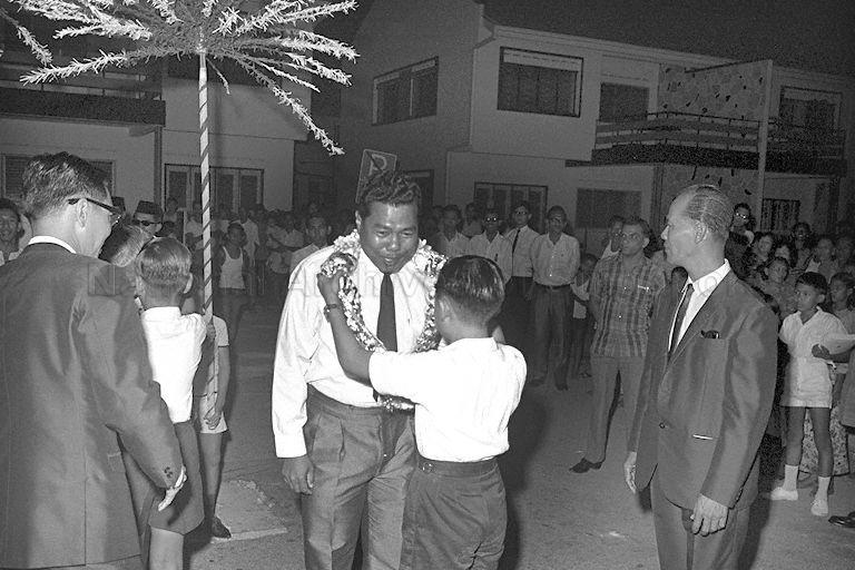 Member of Parliament for Kampong Chai Chee Sha'ari Bin Tadin being garlanded on his arrival for opening of Telok Kurau East School at Lorong J, Telok Kurau.