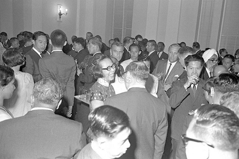 Kwa Geok Choo (centre), wife of Prime Minister Lee Kuan Yew talking with guests at a reception held following the opening of Singapore Parliament in Parliament House, Empress Place