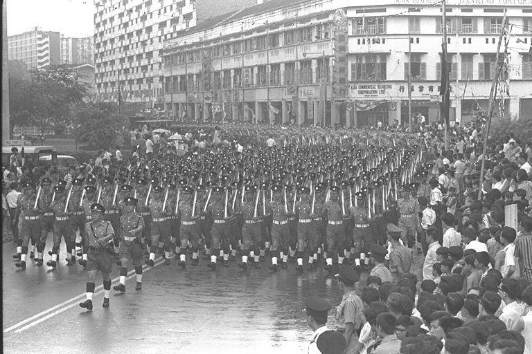 National Day Parade 1968 at the Padang - Singapore Police Force contingent marching past spectators at junction of Havelock Road and Nile Road