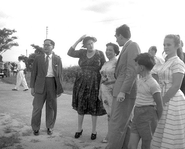 Lady Dorothy Macmillan (touching hat), wife of British Prime Minister, being flanked by Chief Minister Lim Yew Hock (left) and his wife (right) during a tour of Singapore's city.