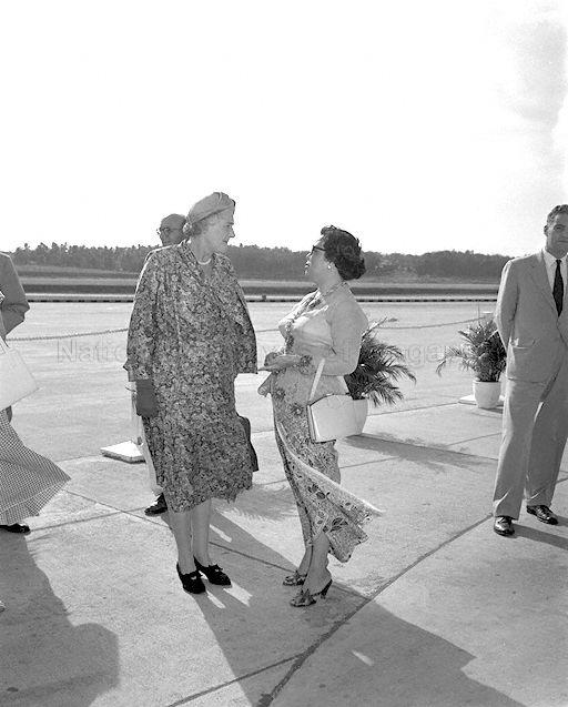 Lady Dorothy Macmillan (left), wife of British Prime Minister, talking to Mrs Lim Yew Hock (centre), wife of Chief Minister, before boarding her plane for London.