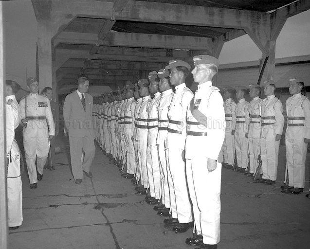 The last Governor of Singapore and first Yang Di-Pertuan Negara of Singapore Sir William Goode inspecting the guard of honour mounted by Singapore Infantry Regiment before he leaves Singapore