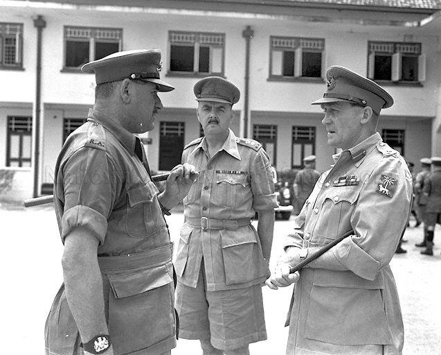 General Officer Commanding of Singapore Base District Major-General A G O'Carroll Scott (right) chatting with army officers during his visit to Singapore Volunteer Corps