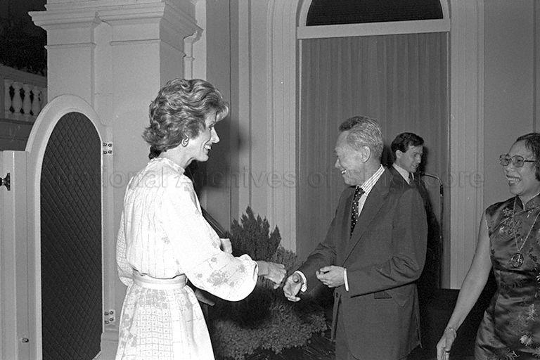 Prime Minister and Mrs Lee Kuan Yew greeting Mrs Nancy Kissinger, wife of former Secretary of State of United States Dr Henry Kissinger, when she arrives at Istana to attend dinner for delegates of a two-day meeting under the auspices of Aspen Institute of Humanistic Studies