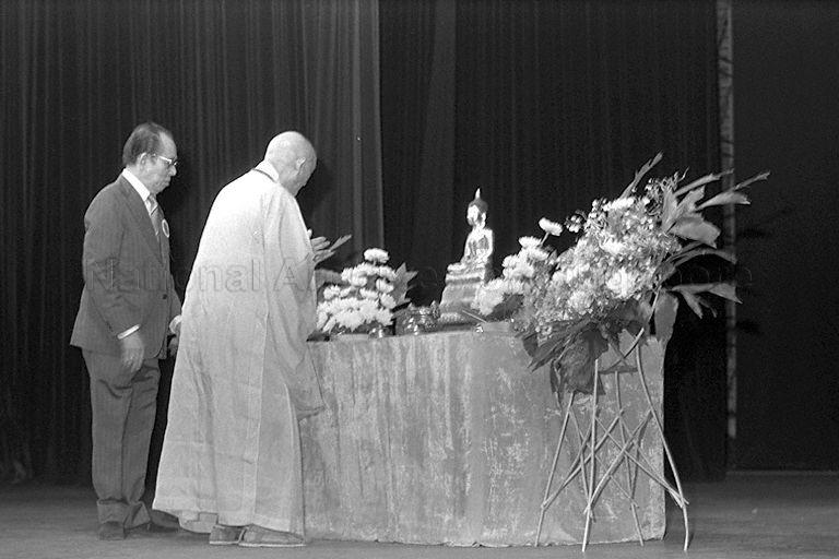 Abbot of Kong Meng San Phor Kark See Monastery (or Bright Hill Temple) Venerable Seck Hong Choon (back to camera), who is also President of Singapore Buddhist Federation, presiding over Vesak Day celebration at National Theatre