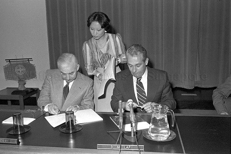 Managing Director of Philips Singapore B M Lap (right) signing contract for supply of long-range radar and display system (Lorads) for new international airport at Changi with Singapore Government at Port of Singapore Authority conference hall