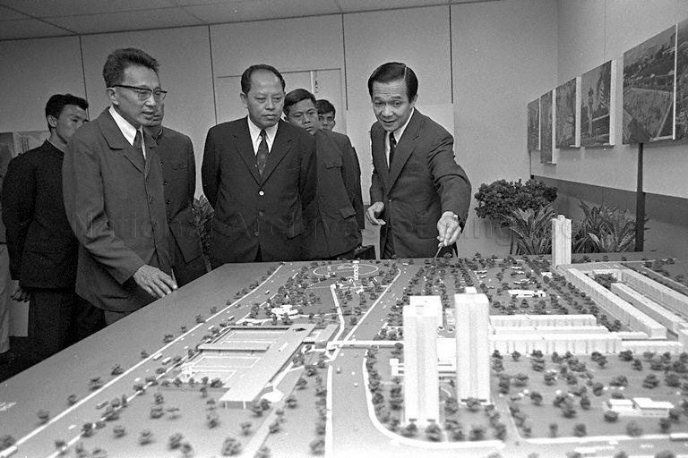 Deputy Prime Minister for Foreign Affairs of Democratic Kampuchea (now Cambodia) Ieng Sary and his delegation taking a guided tour of the Housing and Development Board (HDB) office, led by Chairman of HDB Michael Fam (right)