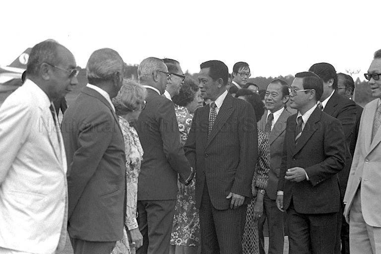 Thai Prime Minister (PM) General Kriangsak Chomanan, assisted by Chief of Protocol at Ministry of Foreign Affairs Tan Keng Jin (on his left), saying goodbye to Minister for National Development Lim Kim San at Paya Lebar Airport as PM Lee Kuan Yew, Deputy PM and Minister of Defence Dr Goh Keng Swee, Minister for Foreign Affairs S Rajaratnam and Mrs Rajaratnam look on. General Kriangsak is leaving at end of his three-day official visit to Singapore.