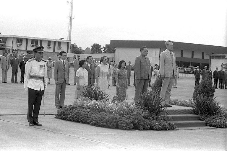 Prime Minister Lee Kuan Yew accompanying the People's Republic of China Senior Vice-Premier Teng Hsiao-Ping (Deng Xiaoping) at the ceremonial send-off at Paya Lebar Airport. Standing from second left are, Minister-in-attendance, Minister for Communications and Acting Minister for Culture Ong Teng Cheong, Madam Cho Lin, the Senior Vice-Premier's wife, Chief of Protocol, Ministry of Foreign Affairs Tan Keng Jin, Mrs Lee and Mrs Ong. The Senior Vice-Premier is on a three-day visit to Singapore as part of his three-nation tour of South-East Asia that includes Thailand, Malaysia and Singapore.