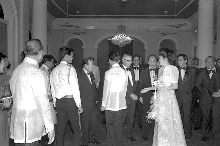 Philippine President Ferdinand Marcos (centre, wearing a traditional Barong Tagalog shirt) and First Lady Imelda Marcos meeting guests during a reception before the start of the State Dinner in the Istana