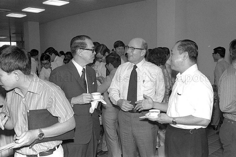 Minister for Finance Hon Sui Sen (in blazer suit), and Permanent Secretary (Prime Minister's Office) and Head of Civil Service Howe Yoon Chong (foreground, right) talking to a guest at a reception during the opening of Civil Service Staff Development Institute building in Heng Mui Keng Terrace, Pasir Panjang.