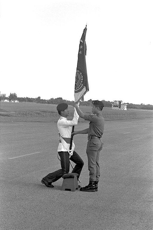 Lieutenant-Colonel Clarence Tan, Commanding Officer of the First Commando Battalion--the best combat unit for 1974--receiving the Singapore Armed Forces (SAF) colours on behalf of his unit, during the SAF display at Changi airfield