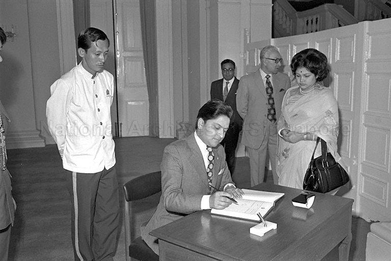 Prince Dhirendra of Nepal, accompanied by his wife, Princess Prekshya Rajalaxmi Devi, signing the guest book during a courtesy call on President Dr Benjamin Sheares in the Istana