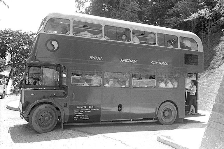 Kwangchow Acrobatic Troupe of China taking a double-decker bus for sightseeing tour on Sentosa island