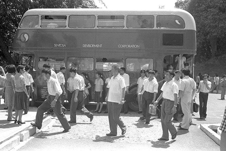 Kwangchow Acrobatic Troupe of China taking a double-decker bus for sightseeing tour on Sentosa island