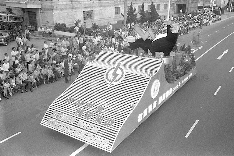 National Day Parade 1973 Rehearsal at the Padang -- People's Action Party (PAP) float moving past spectators along St Andrew's Road