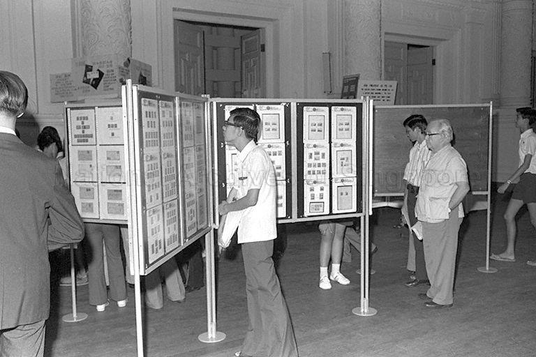 Visitors viewing stamp exhibits at 1973 National Stamp