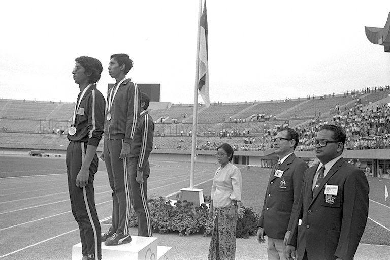 Singapore's high jumper Nor Ashar Hamid at the victory podium as the national anthem is played at the Seventh Southeast Asian Peninsular (SEAP) Games at National Stadium, Singapore. Nor was acclaimed the best in Asia with a record-shattering 2.12 metres.