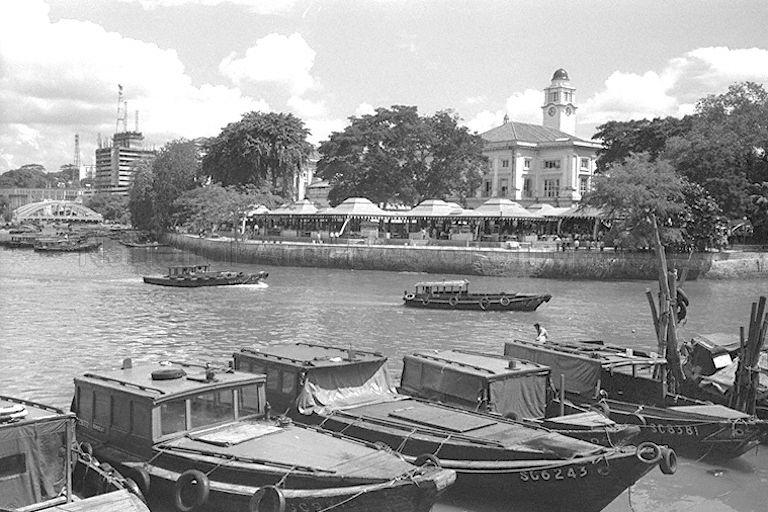 Empress Place Food Centre along Singapore River. In the background on the right are Empress Place Building and the clock tower of Victoria Theatre