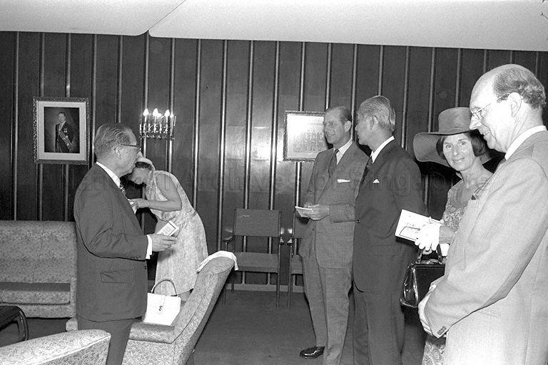 Duke of Edinburgh Prince Philip speaking to Chairman of Singapore Turf Club Tan Sri Runme Shaw before lunch is served at the club