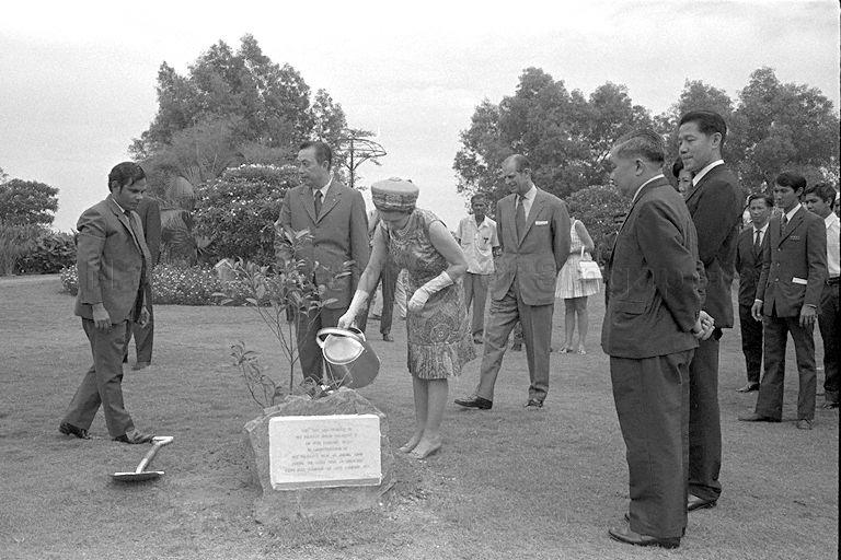 Queen Elizabeth II planting a tembusu tree at Jurong Hill as Duke of Edinburgh Prince Philip, Chairman of Jurong Town Corporation (JTC) Woon Wah Siang and other officials look on