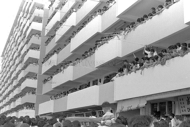 Residents of Toa Payoh lining the corridors of a Housing and Development (HDB) flat at Lorong 5, in order to catch a glimpse of Queen Elizabeth II during her visit to the housing estate