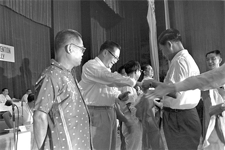 Chan Yoon Onn from People's Progressive Party being presented with silk banner during Malaysian Solidarity Convention held at National Theatre