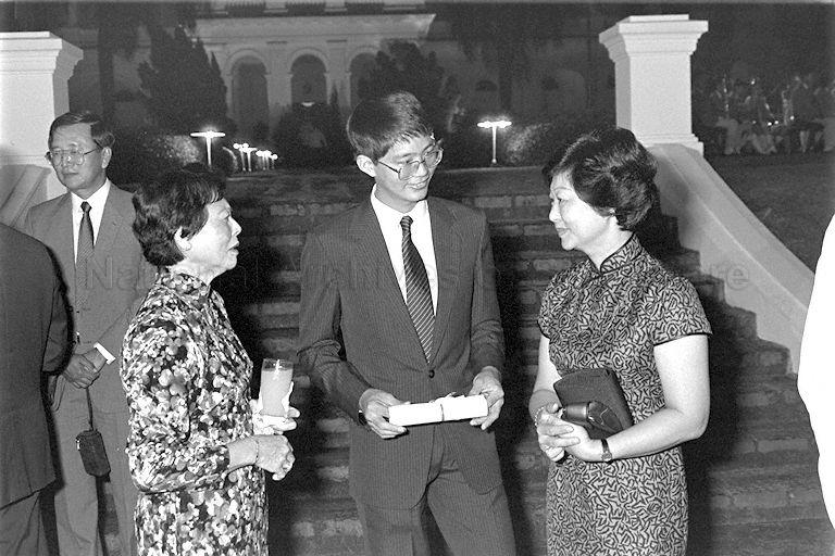 President Scholar Patrick Tan Boon Ooi in conversation with his mother Mrs Mary Tan (right), wife of Minister for Education and Mrs Wee Kim Wee (left), wife of President during President's Scholarship awards presentation held at Istana 