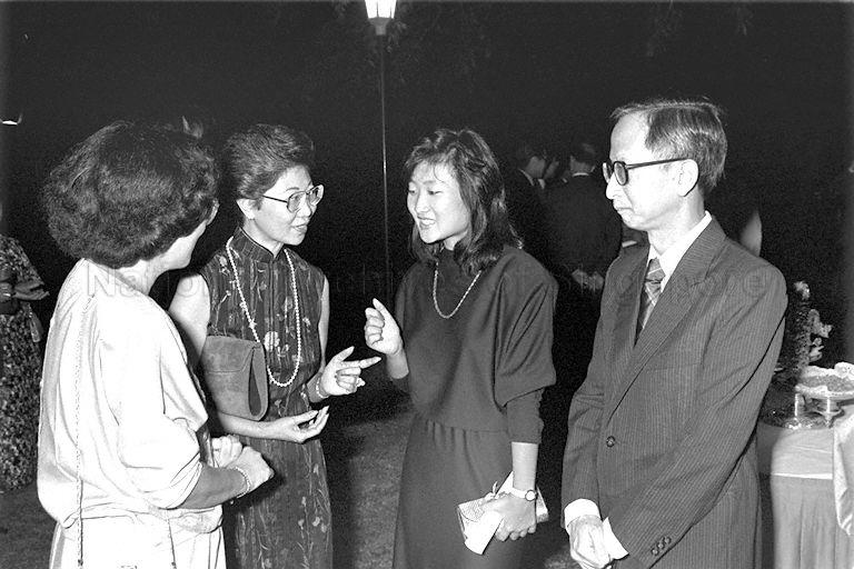 President Scholar Valerie Thean Pik Yuen (second from right) with parents Justice L P Thean (right) and Mrs L P Thean (third from right) chatting with guest at reception following the President's Scholarship awards presentation at Istana.