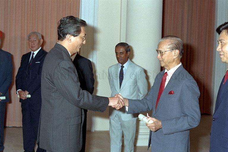 Chua Gim Siong receiving Instrument of Appointment as member of Presidential Council for Religious Harmony from President Wee Kim Wee at Istana. Minister for Law and Home Affairs S Jayakumar (in light grey suit) and Chief Justice Yong Pung How (hidden) were witnesses for the ceremony.