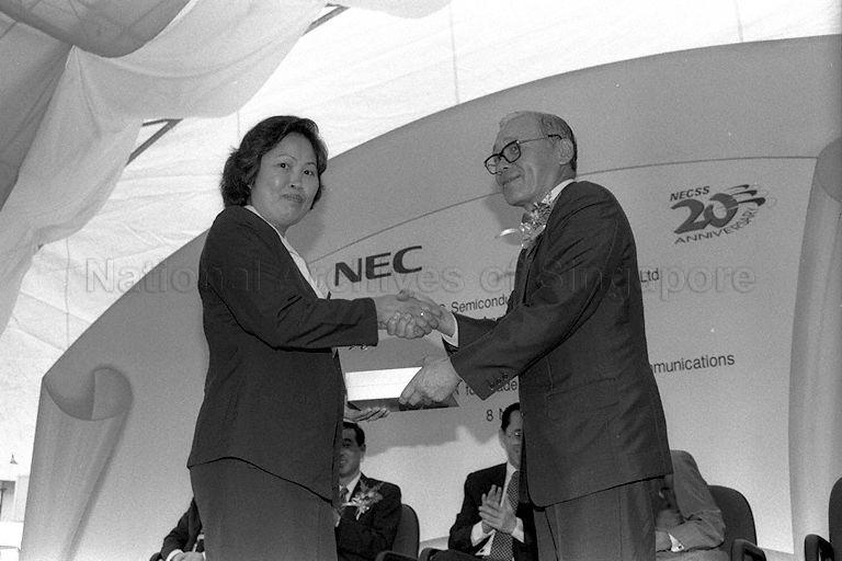 Official from NEC Semiconductor (S) Private Limited presenting token of appreciation to staff during the company's 20th anniversary ceremony held at 38, Ang Mo Kio Industrial Park II.