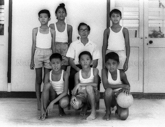 Members of Haig Boys' School volleyball team and their teacher posing for photograph