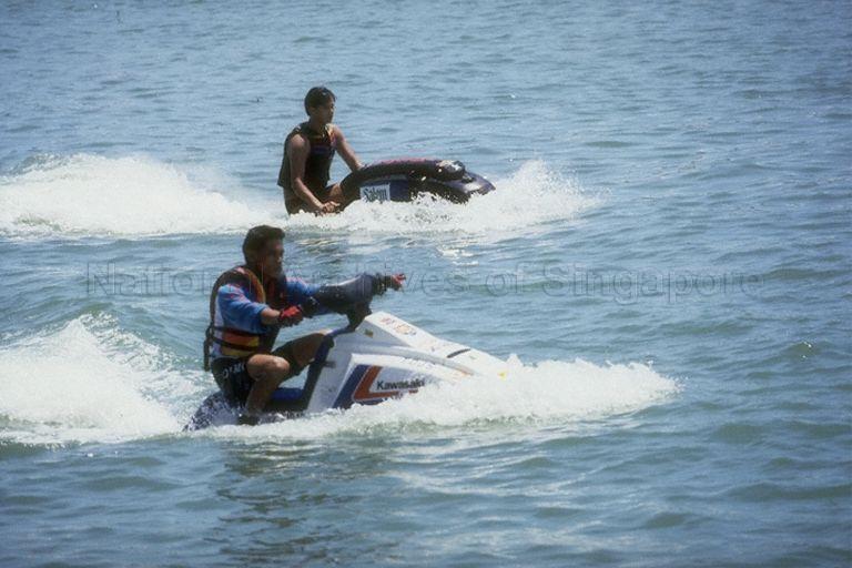 Sailpast of pleasure craft, including jet skis, during opening of Singapore Powerboat Grand Prix at the Marina Bay