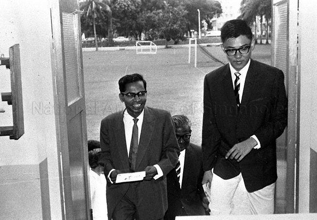 Guest-of-Honour, Head of Department of Anatomy at University of Singapore, Professor Kanagasuntheram (left) entering hall for the Raffles Institution Geography and Science Exhibition. Walking behind is Prinicipal E W Jesudason.