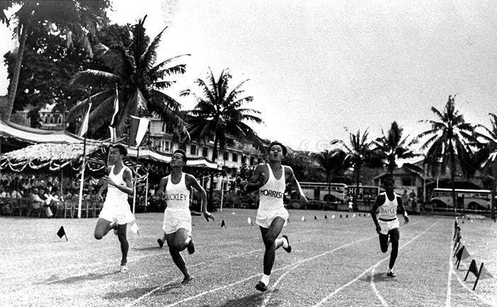 Participants of the 100-yard (Class 2) sprint dashing to a close finish at Raffles Institution Sports Day. Heng Jee Yong of Morrison House won the race.
