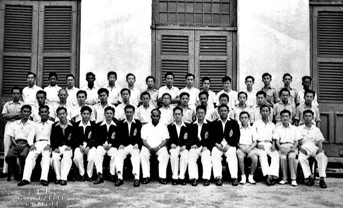 Group photograph of School Certificate Class A (1948): <br />FRONT (from left) Chua Choo Lim, Wong Yip Chong, Lai Min Tet, Yeo Oon Hock, Tung Siew Yoon, Woon Sui Cheong, Mr V Ambiavagar (form teacher), Wong Yuen Poh, Lim Kam Choon, Tan Eng Poh, Yeo Oon Swee, Tan Boon Seng, Seow Teng Kia and Loo Soon Cheng;<br />MIDDLE (from left) Hsu Tse Kwang, Goh Teck Seng, Lo Hock Ling, Tan Seng Huat, Eugee Liow, Tan Hung Boon, Leong Vie Ying, Lo Hong Ling, Wong Choon Fook, Musa Yusof, Quah Cheong Hock, Yip Fook Seng, Ho Tung Ya, Yeoh Oon Teng and Poh Soo Kai;<br />BACK (from left) Yong Nam Seng, Dilip Singh, Leong Vie Chung, Alex Thomas, Chia Siew Hock, Wong Geok Hua, Koh Watt Seng, Koh Tiong Seng, Pang Tee Pow, Chia Kim Hui, Lee Tat Seng, Si Hoe Koh Wan, Seah Keng Toh, Chan Mun Heng and Gunaratnam.