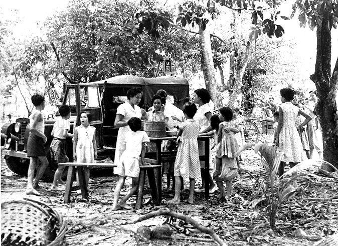 View of Dr Lam Sian Lian and mobile immunisation team carrying out work at a kampong. Dr Lam retired as Chief Executive Officer of Health Promotion Board in September 2005.