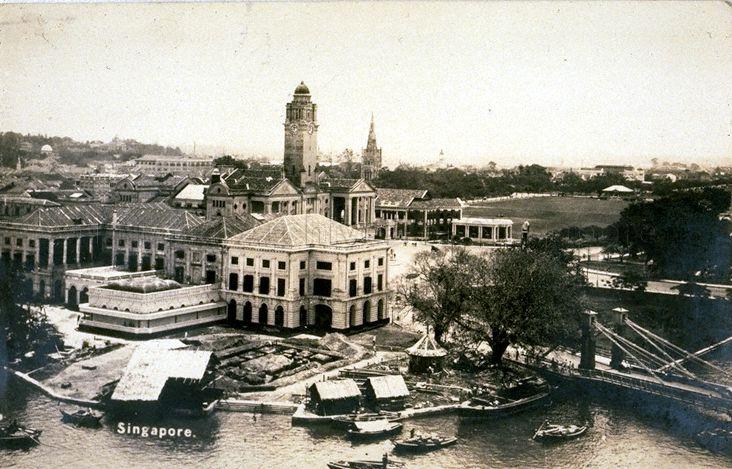 View of buildings at Empress Place, Singapore. These include the Victoria Theatre and Memorial Hall (with clock tower) and St Andrew's Cathedral (with spire).