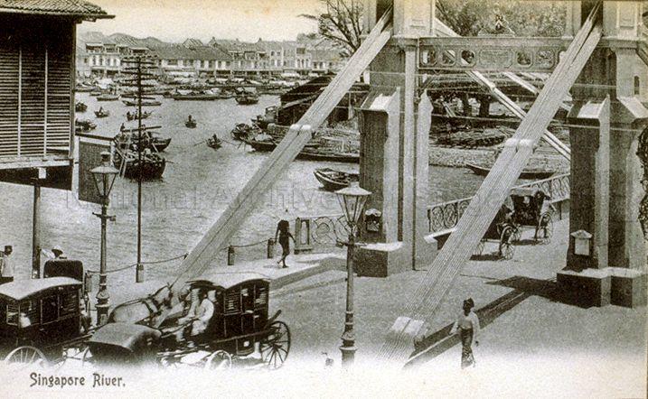 Cavenagh Bridge overlooking the Singapore River. This picture was taken before status of the bridge was reduced from major thoroughfare for wheeled traffic to footbridge in 1910, with a ban on bullock carts, horse carriages and vehicles exceeding three hundredweight (152 kg)